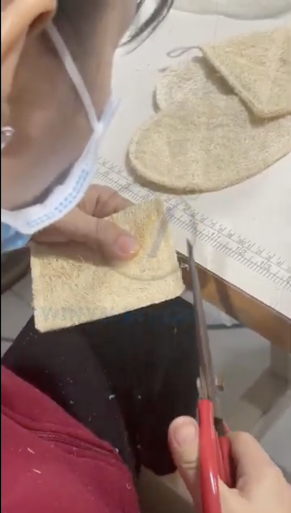 Trimming and finishing the edges of cut natural loofah pads by hand