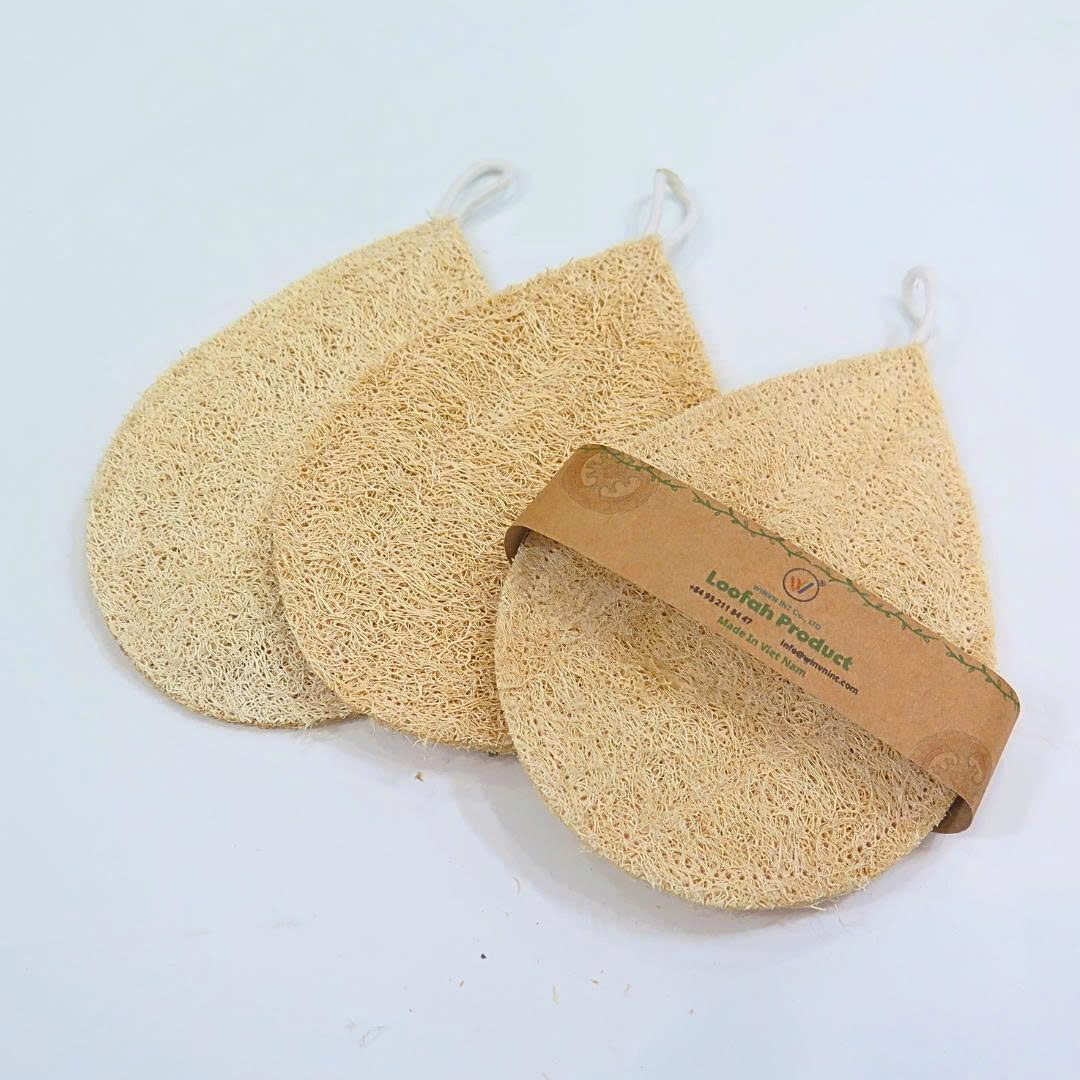 Unbleached natural loofah bath pads showing warm cream color and fiber texture