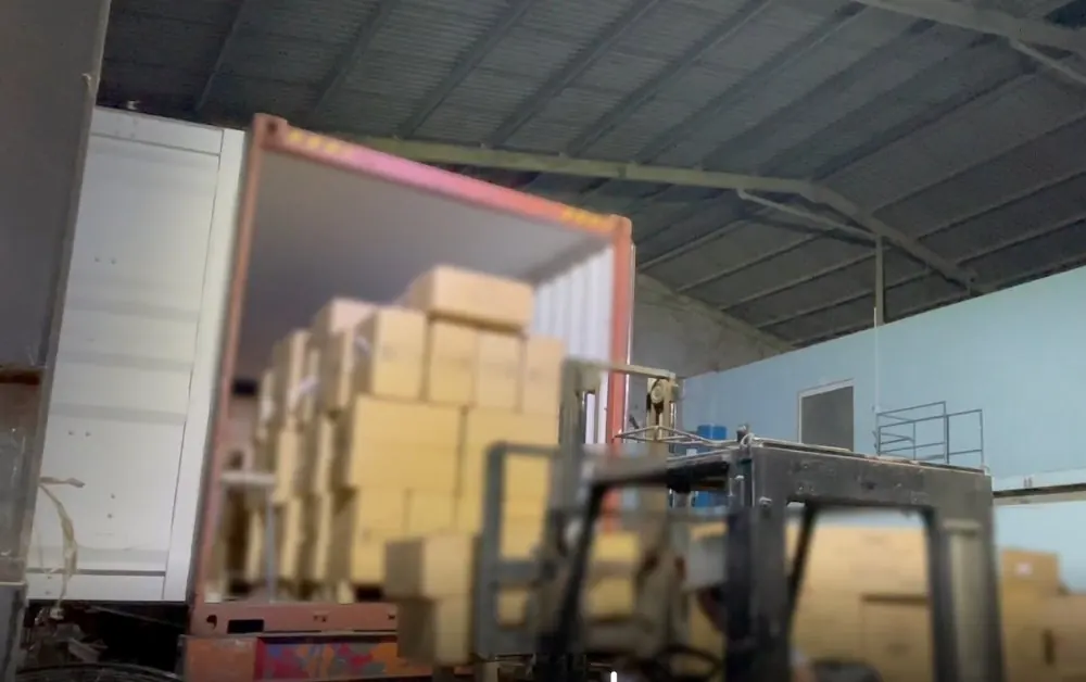 Loading finished boxes into an export container